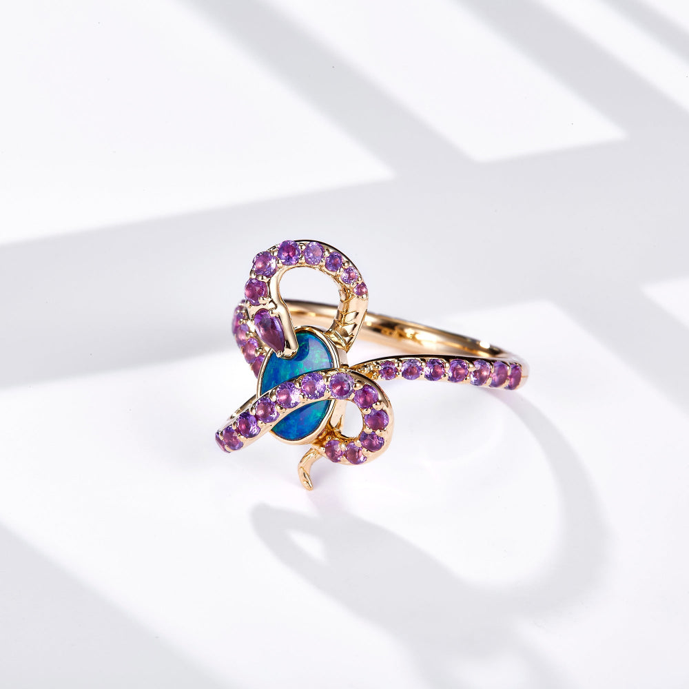 18K gold ring featuring an oval Australian opal with a snake design set in yellow gold, adorned with natural amethyst gemstones for a vibrant contrast.