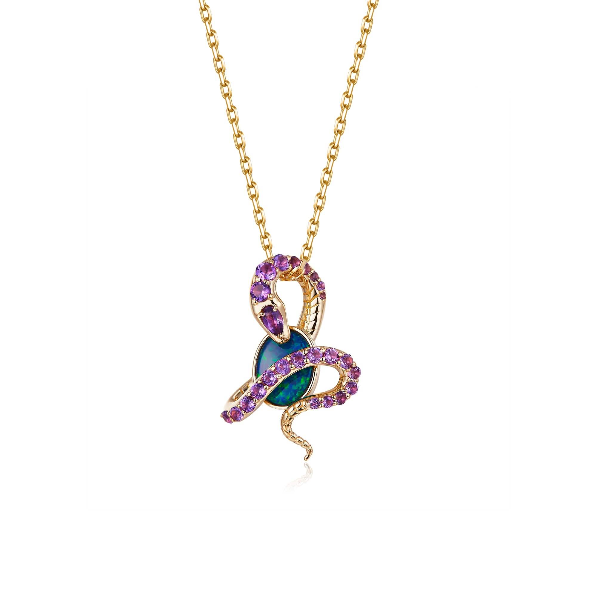 An 18K gold pendant necklace featuring an oval Australian opal wrapped in an intricate snake design adorned with natural amethyst gemstones. The opal displays vibrant blue-green hues, beautifully contrasted by the rich purple of the amethysts and the warm yellow gold setting. The pendant hangs from a delicate gold chain, creating a bold yet elegant statement piece.